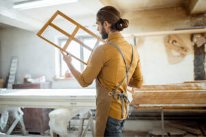 carpenter with window frame at the workshop 2021 08 31 13 53 48 utc